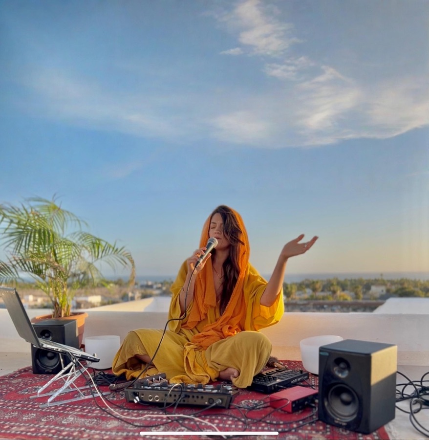 Marsseia singing at a rooftop sound ritual at sunset