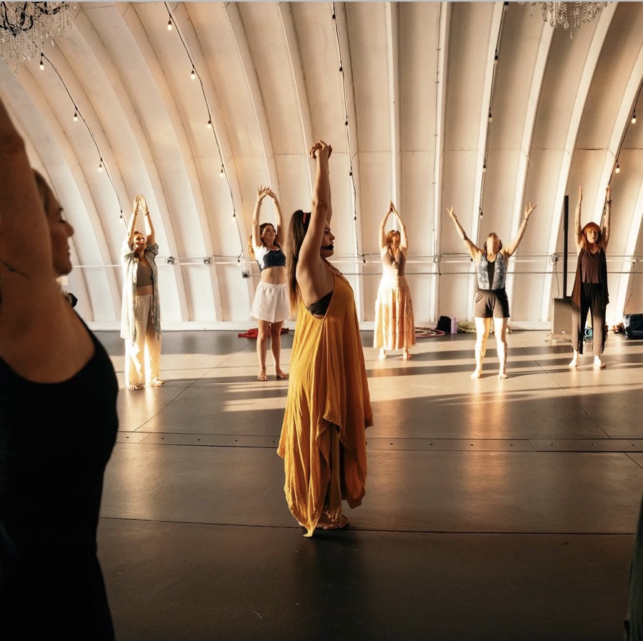Dancers raising their arms during a Sacred Embodiment workshop